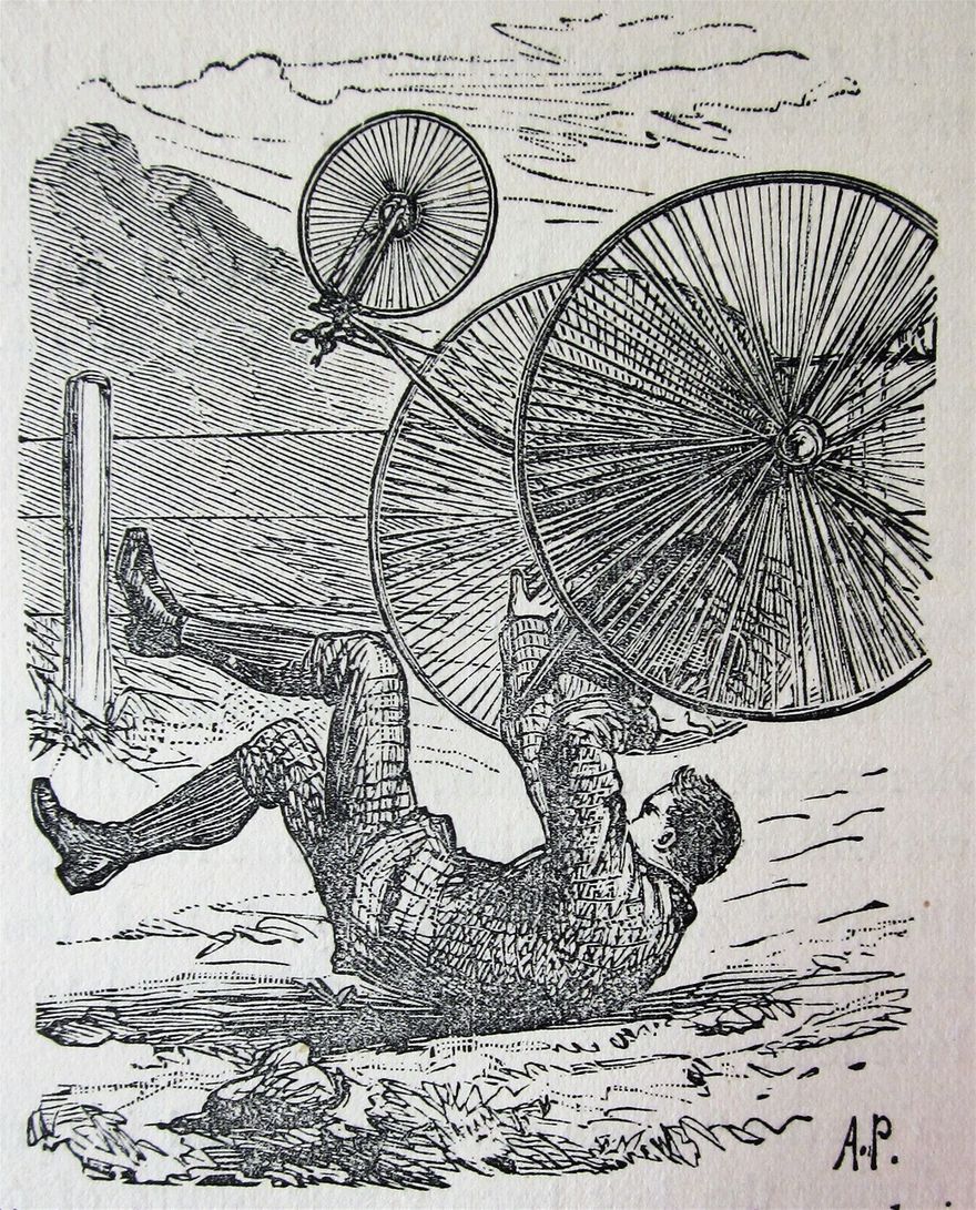 On the broad of his back, with his tricycle on top of him.