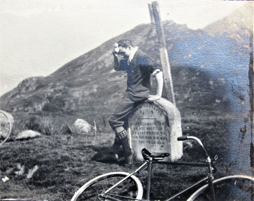 A cyclist recovers after the long, slow climb up to Rest and be Thankful in the Glencoe district. A photo dated 1899 on the back.